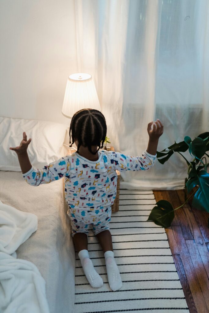 child by bed